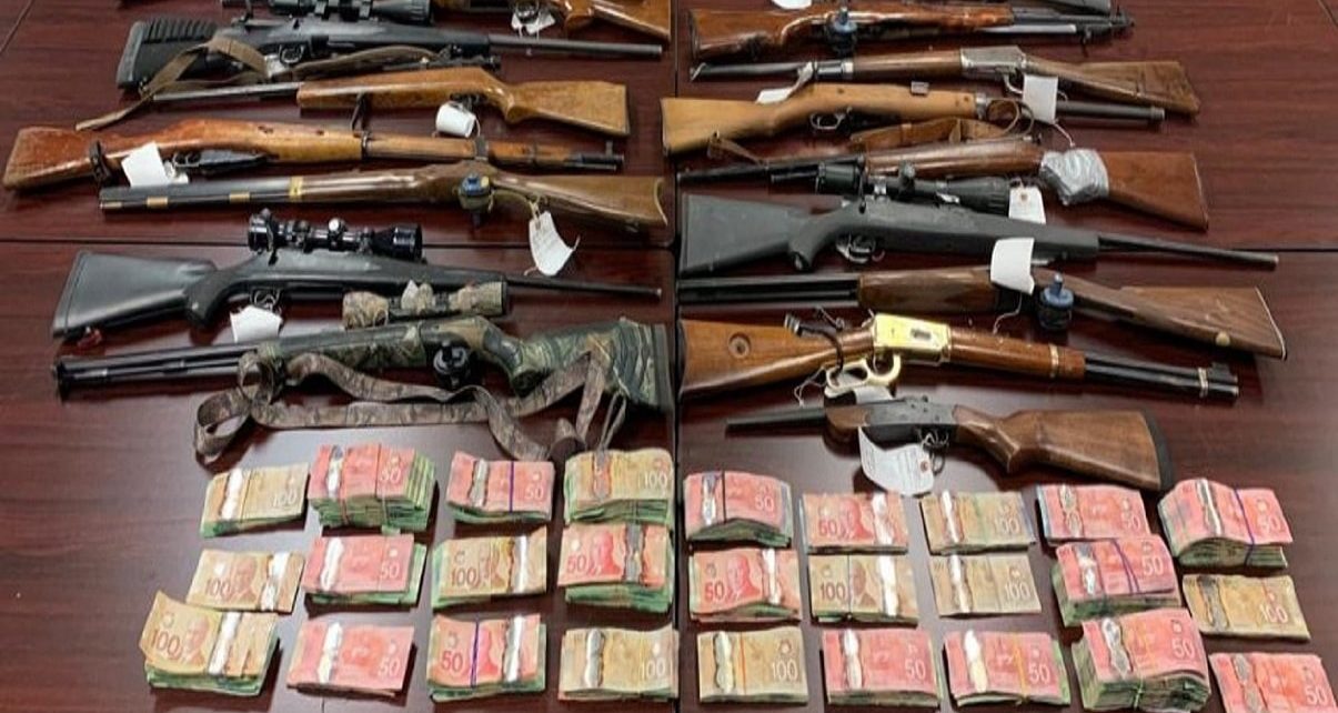 Firearms and money seized after police execute search warrant
