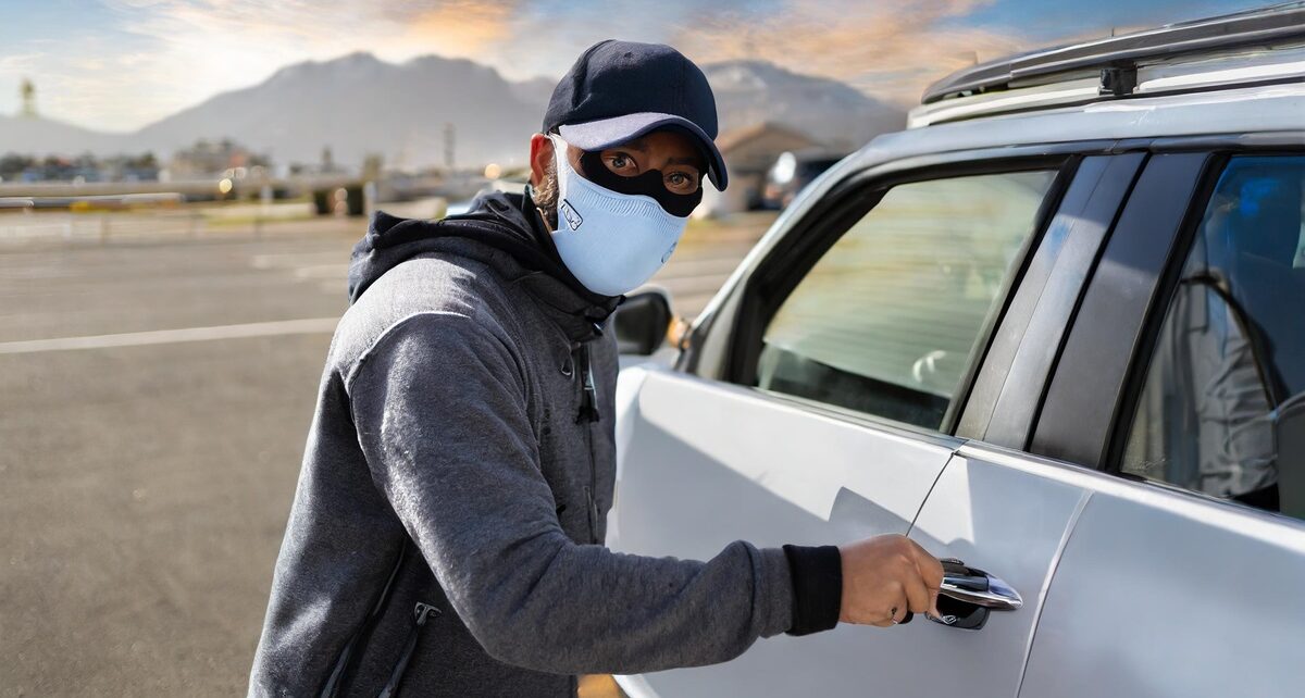 Government of Canada Takes Bold Steps to Combat Rising Auto Theft Rates 1731 Firefly generate a white man opening a car door with a knife wearing ski mask in a parking lot 34001