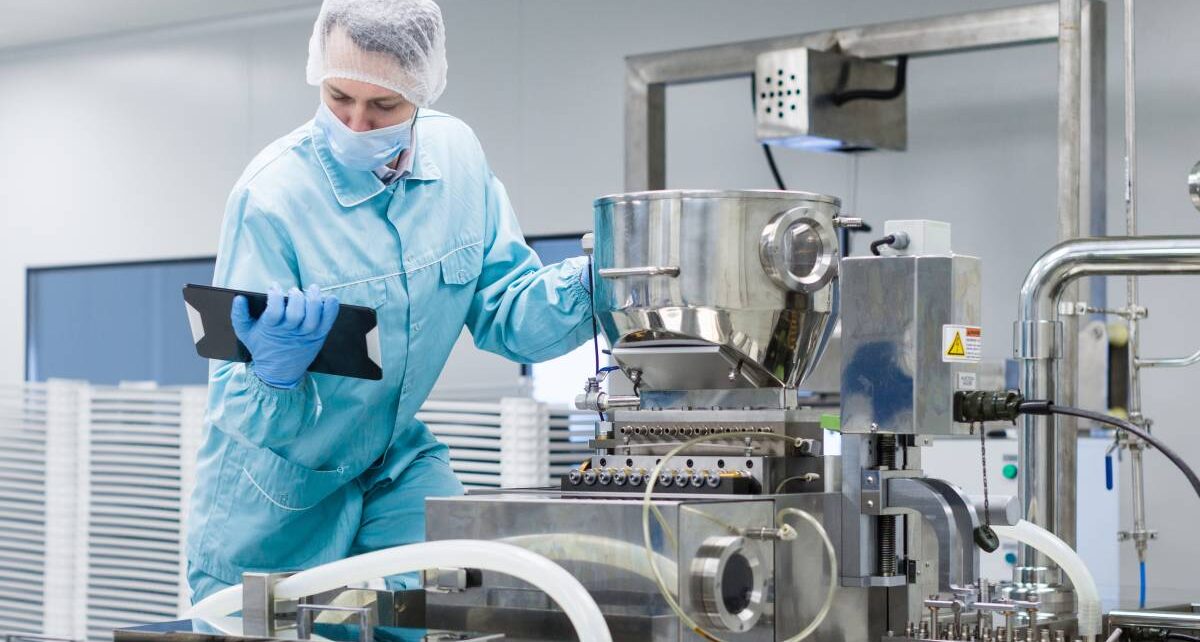 How Food Manufacturers Combat Premature Food Spoilage 143 A food manufacturing scientist holding a tablet as he examines time-sensitive product held in processing equipment.