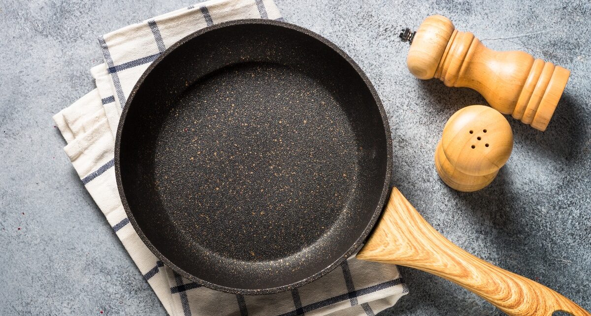 Common Household Objects Made With PEEK Plastic 30 A non-stick cooking pan with a heavy-duty plastic handle and a textured finish on the cook surface. It's sitting on a towel.