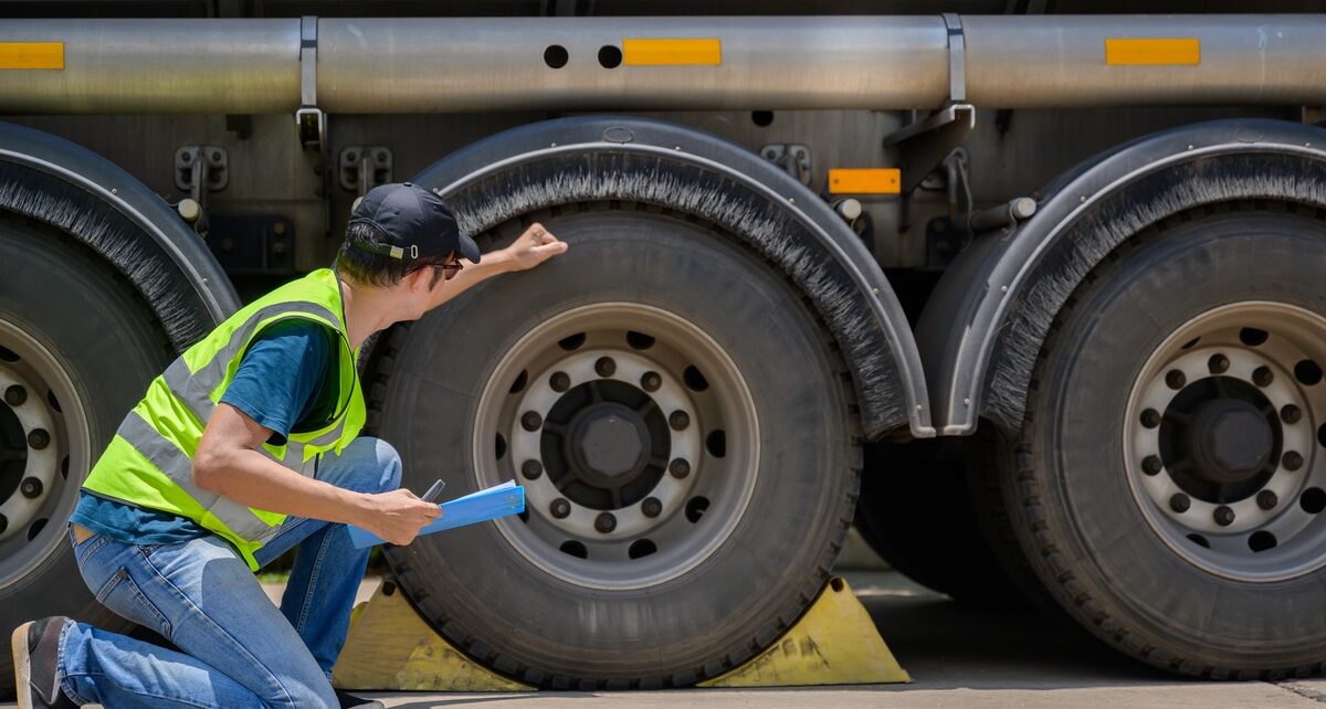 GirardEquipment-379722-man-inspecting-truck-image-1