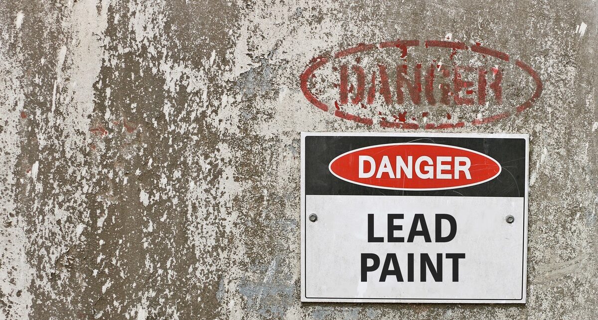 Dangerous Materials We Used To Use Every Day 53 On a wall with chipping white paint sits a sign stating Danger Lead Paint with the word DANGER stamped on the wall.